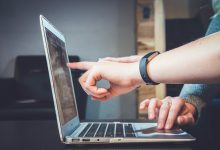 People collaborating with laptops, illustrative photograph