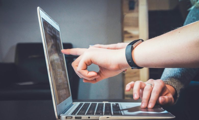 People collaborating with laptops, illustrative photograph